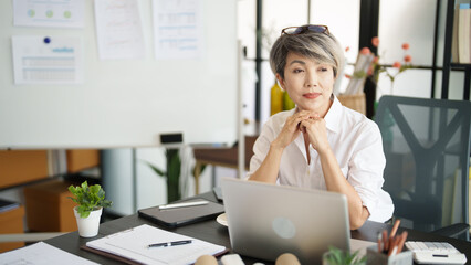Senior business asian woman mature working in office