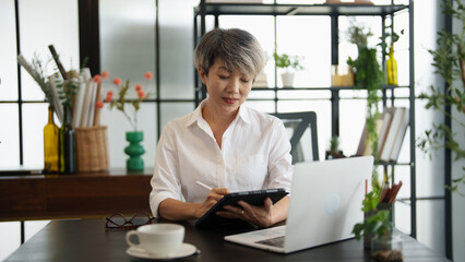 Senior business asian woman mature working in office