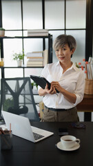 Senior business asian woman mature working in office