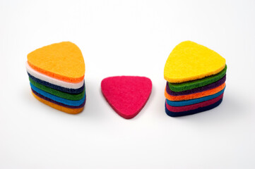 Felt picks in different colors for playing the ukulele or other string instruments.