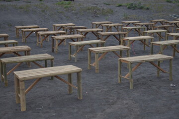 Rows of Bamboo Benches on Volcanic Sand