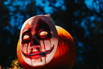 Horrible halloween background.Scary Mask on Pumpkin for Halloween. Halloween holiday.