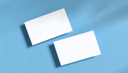Top-down layout of two white business cards, blue background