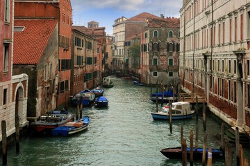 View of the wonderful small canals, distributed throughout the neighborhoods of Venice, Italy.