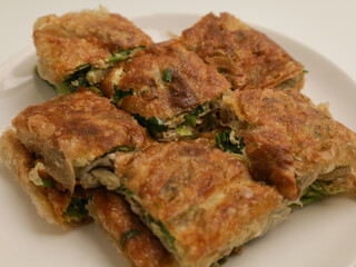 Martabak telur or thin pastry filled with meat, egg and spring onion and fried