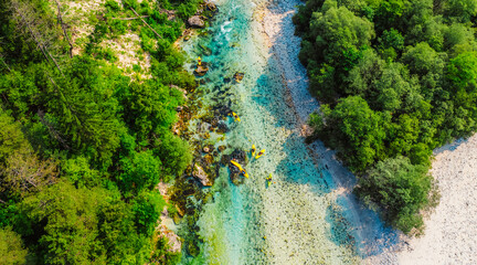 Rafting and kayaking place on the river. Kayakers in colorful life jacket paddling in Soca river,...