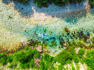 Rafting and kayaking place on the river. Kayakers in colorful life jacket paddling in Soca river, Bovec in Triglav National Park, Slovenia