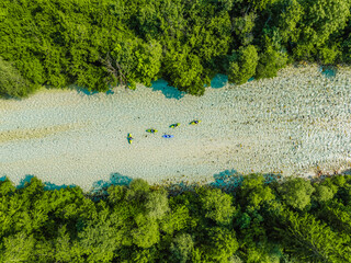 Rafting and kayaking place on the river. Kayakers in colorful life jacket paddling in Soca river,...