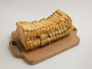 Toasted bread on wooden tray