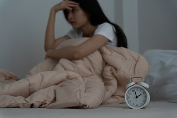 asian woman in bed late trying to sleep suffering insomnia, sleepless or scared in a nightmare,...