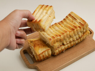 Toasted bread on wooden tray