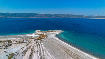 The tranquil beauty of Salda Lake - Turkey with its crystal clear turquoise waters and stunning surrounding landscapes is a mesmerizing sight to behold.