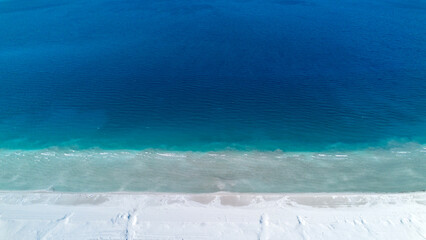 The tranquil beauty of Salda Lake - Turkey with its crystal clear turquoise waters and stunning surrounding landscapes is a mesmerizing sight to behold.