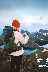 Woman traveling in Norway taking photo using smartphone in mountains blogger tourist hiking with...