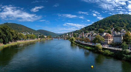 Fototapeta premium Panoramic river view of a town nestled in hills