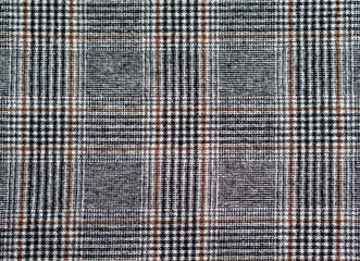 Classic checkered fabric background. Traditions of suit sewing. White, black and brown checkered pattern