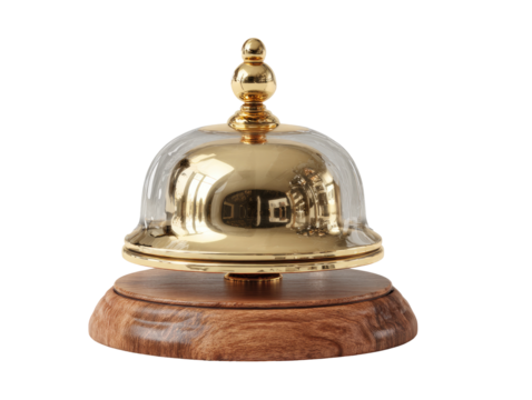 Polished gold bell with clear glass dome, resting on a wooden base