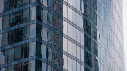 walls and empty windows of a modern building on a big city street without people