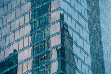 walls and empty windows of a modern building on a big city street without people