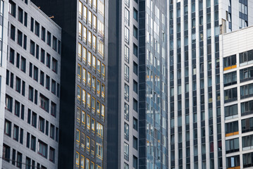 empty glass windows of a modern building with a reflection of the sky in the glass