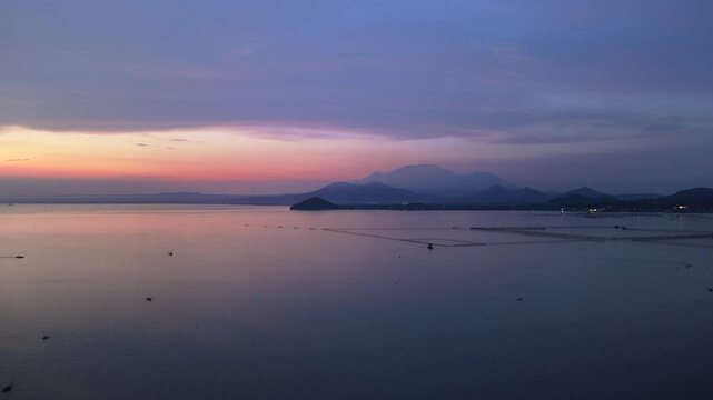 Scenic panorama aerial drone video of Mount Banahaw and Laguna de Bay during Sunrise with mist, Calamba, Laguna, Philippines