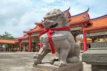 Lion statue at the Chinese temple entrance . Guardian and protector of the temple's gate . 