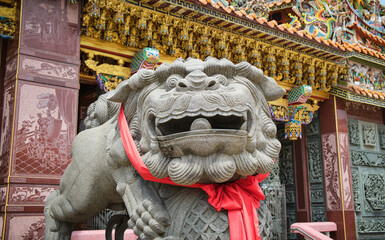 Lion statue at the Chinese temple entrance . Guardian and protector of the temple's gate . 