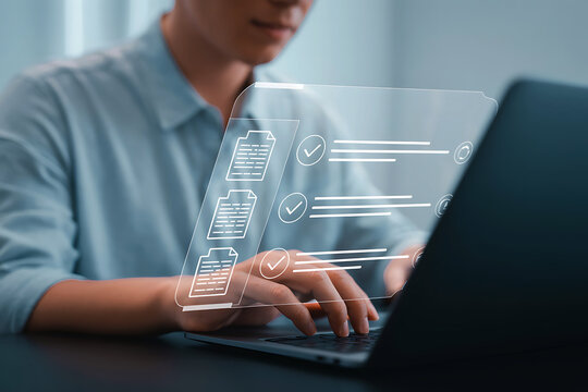 Person typing on a laptop with glowing digital data overlay