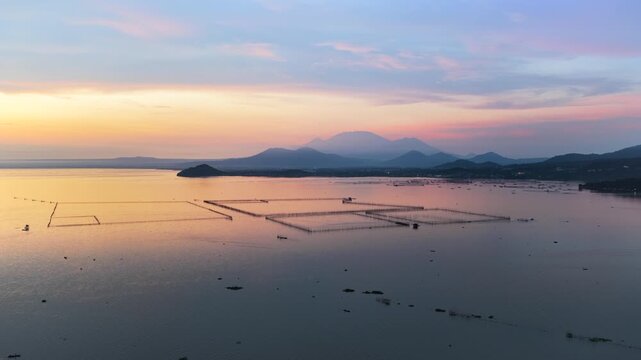 Scenic panorama aerial drone video of Mount Banahaw and Laguna de Bay during Sunrise with mist, Calamba, Laguna, Philippines
