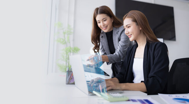 Two asian business woman working together for analysis data plan business strategies in office, Business discussing and startup concept.