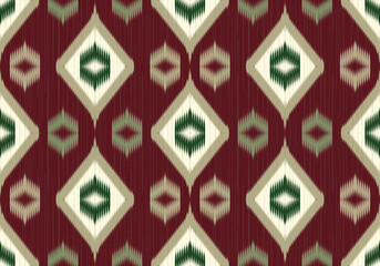 A bold seamless Ikat pattern using green gradient and cream hues forming vivid diamond motifs with sharp angular layers, on deep red background reflecting strong tribal influences.