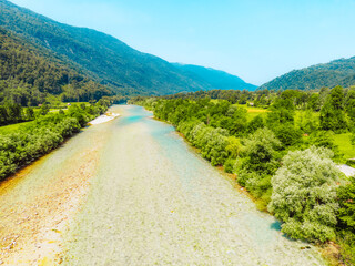 Rafting and kayaking place on the river. Kayakers in colorful life jacket paddling in Soca river,...