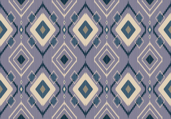 A bold seamless Ikat pattern using green, blue and cream diamond motifs on soft grey background with symmetrical angular layers, reflecting strong tribal influences.