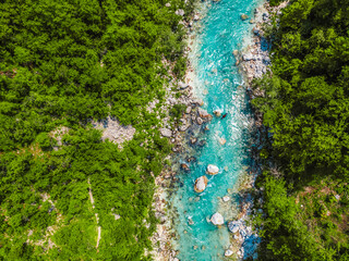 Fototapeta premium Rafting and kayaking place on the river. Kayakers in colorful life jacket paddling in Soca river, kobarid, Triglav National Park, Slovenia