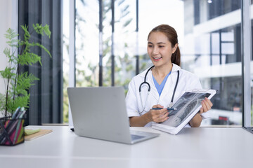 Smiling Female Doctor with Clipboard and Laptop for Online Medical Consultation working in Modern Clinic.