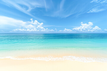 Fototapeta premium Sandy Beach Under Bright Blue Sky with Gentle Waves