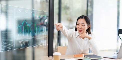 businesswoman working on digital tablet with financial analysts reports and planning investment at office.