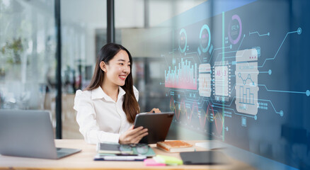businesswoman working on digital tablet with financial analysts reports and planning investment at office.