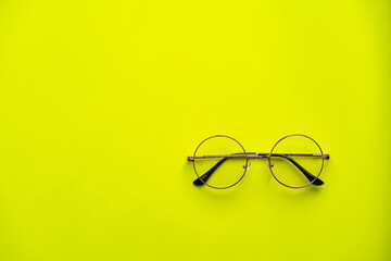 Round Glasses on Yellow Background