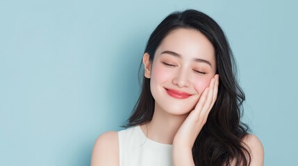 A woman with long hair is smiling and resting her chin on her hand. She has red lipstick on and her eyes are closed