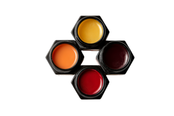 A group of five different lip balms in black glass jars arranged on top of each other to form the shape of an octagon with isolated on a transparent background in PNG format.