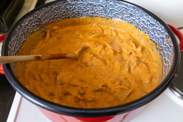 Creamy mushroom stew in red pot