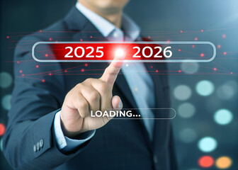 A man is loading year 2025 to 2026 by placing his finger on a screen. He has made a new idea to develop his job or business. 