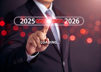 A man is loading year 2025 to 2026 by placing his finger on a screen. He has made a new idea to develop his job or business. 