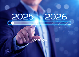 A man is loading year 2025 to 2026 by placing his finger on a screen. He has made a new idea to develop his job or business. 