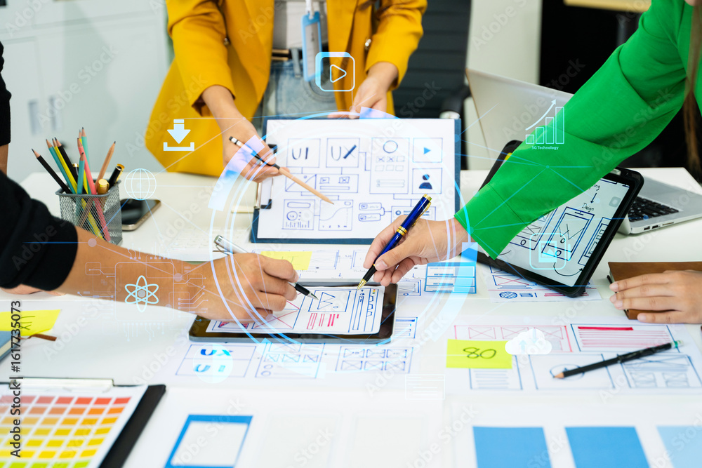 Poster creative team collaborating on ux/ui wireframe designs for a mobile app. hands on planning, sketchin