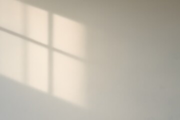 Soft morning window shadow on white wall background