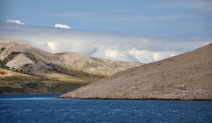 Pag Island, Croatia. Rocks and hills on island Pag.Breathtaking panoramic view of the barren, majestic Pag island across the calm, blue Adriatic Sea © Marilena