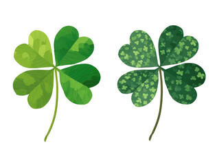 Two stylized four-leaf clovers, one smooth and one patterned.  Both are vibrant shades of green on a black background.  The patterned clover has small, repeating shapes or dots.  