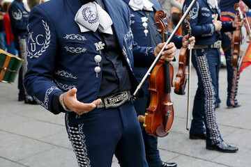 Mexican musicians wearing traditional costumes in a folklore parade